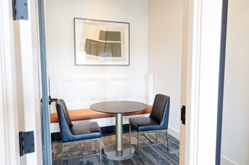 A modern room with a table and two chairs at The Crest at South Point Apartments, Georgia, 30253